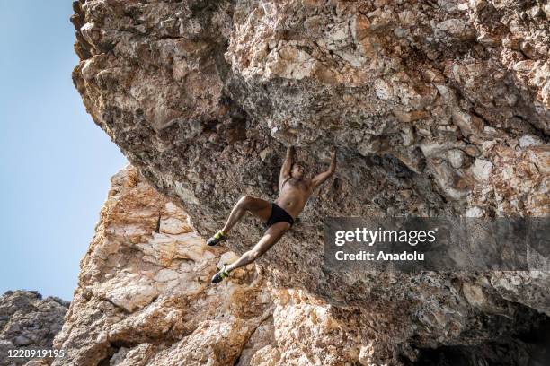 Metin Yilmaz who has been a guide for diving, kayaking and climbing for 20 years in the area, climbs a rock in "Suluada" which is located 7...