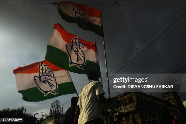 Activists of the Congress party with party flags walk in a rally protesting in opposition to atrocities against women in Utaar Pradesh and all over...