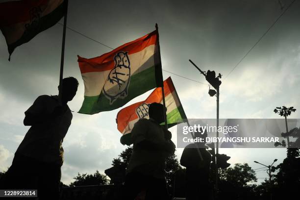 Activists of the Congress party with party flags walk in a rally protesting in opposition to atrocities against women in Utaar Pradesh and all over...