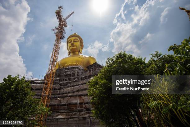 Giant Buddha statue under construction at Wat Paknam Bhasi Charoen temple in west of Bangkok on October 6, 2020 in Bangkok, Thailand. Meditation...