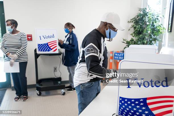 People their cast ballots at the Richland County Voter Registration & Elections Office on the second day of in-person absentee and early voting on...