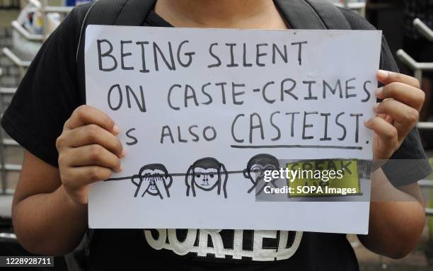 Protester holding a placard during the demonstration. Protesters gathered during a protest against caste based sexual violence happening in different...