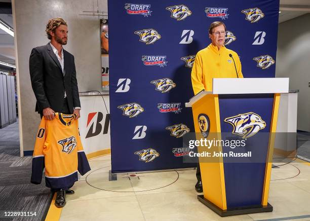 Nashville Predators GM David Poile and team captain Roman Josi prepare to announce goalie Yaroslav Askarov as the 11th pick overall during Round One...