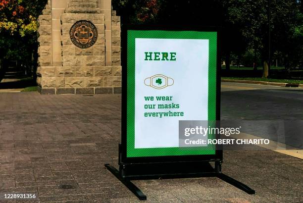 Sign asking to wear masks is seen on the campus of Notre Dame University in South Bend, Indiana on October 6, 2020. - The University of Notre Dame,...