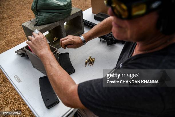 Harriet Hurley loads bullets into the magazine of AR-15 semi-automatic rifle during a shooting course at Boondocks Firearms Academy in Jackson,...