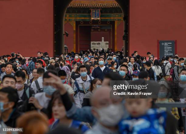 Chinese tourists crowd as they leave the exit of the Forbidden City on October 6, 2020 after tickets sold out during the 'Golden Week' holiday in...