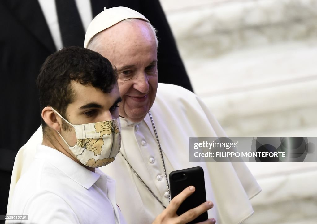 Vatican Mask A worshipper wearing a face mask takes a selfie with Pope Francis as ...