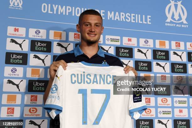 Olympique de Marseille's newly recruited French midfielder Michael Cuisance poses with his new jersey during a press conference in Marseille on...