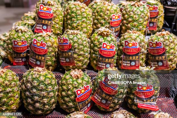 Dole pineapples are seen in a supermarket.