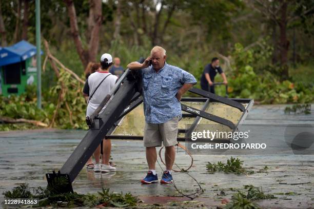 Tourist speaks on his phone outside a shelter after the passage of Hurricane Delta in Cancun, Quintana Roo state, Mexico, on October 7, 2020. -...