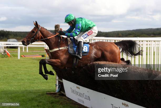 Ga Law ridden by Daryl Jacob clears a fence before going on to win the Subscribe To Racing TV On YouTube Handicap Chase at Exeter Racecourse on...