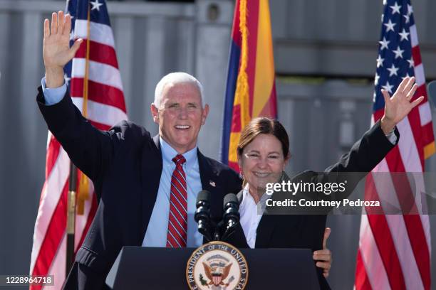 Vice President Mike Pence and second lady Karen Pence and wave to supporters during a 'Make America Great Again' event at TYR Tactical on October 8,...