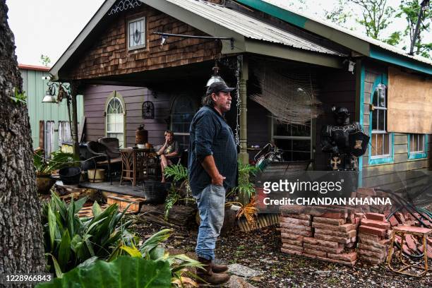 Ison T. Roy stands outside of his house which was destroyed by Hurricane Laura less than 6 weeks ago, a day before upcoming Hurricane Delta in Lake...