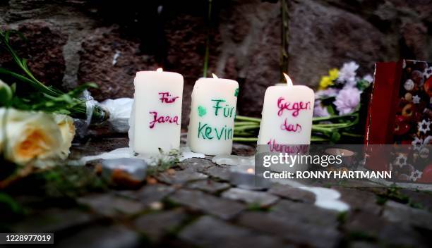 Candles with inscriptions "for Jana" and "for Kevin", refering to the the victims, are lit outside the synagogue in Halle, eastern Germany, on...