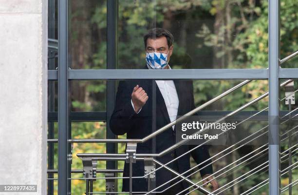 Bavarian Prime Minister Markus Soeder leaves after a meeting with Austria's Federal Chancellor Sebastian Kurz speak to the media after a meeting at...