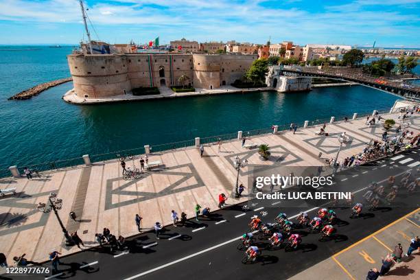 The peloton rides in Taranto city with behind Castello Aragonese during the seventh stage of the Giro d'Italia 2020 cycling race, a 143-kilometer...