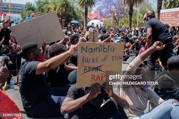 Protester holds a placard during the second day of the #ShutItDown Protests, where hundreds of Namibian youth protested against gender-based violence...