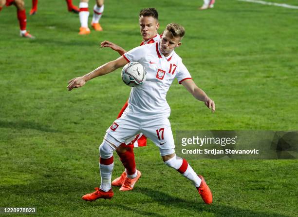 Mateusz Bogusz of Poland in action against Njegos Petrovic of Serbia during the EURO U21 qualifying match between Serbia U21 and Poland U21 at...