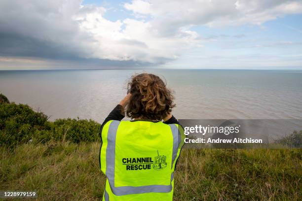 Group of Channel Rescue volunteers monitor the English Channel using telescopes and binoculars searching for small boats of people migrating across...