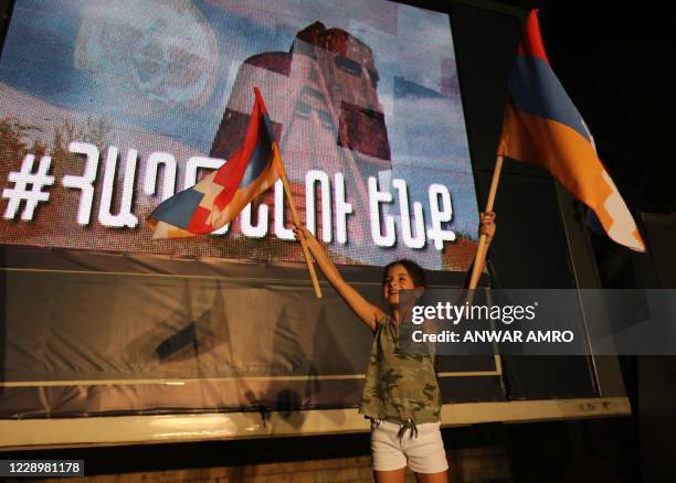 Young Lebanese girl of Armenian origin raises flags of Nagorno-Karabakh as she takes part in a rally organised by the Tashnak party, in support of...