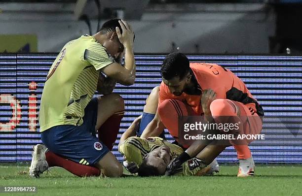 Colombia's Santiago Arias lies injured during the 2022 FIFA World Cup South American qualifier football match against Venezuela at the Roberto...