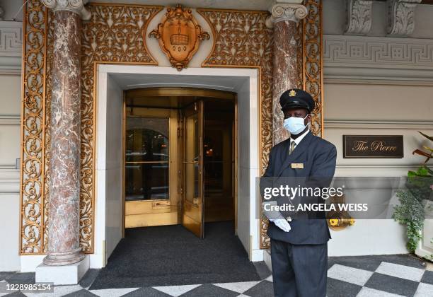 Doorman Isaac stands at the entrance to The Pierre, A Taj Hotel, New York on September 28, 2020 in New York City. - John Farrell and his wife booked...