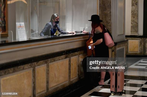 Hotel guest stands at the front desk at The Pierre, A Taj Hotel, New York on September 28, 2020 in New York City. - John Farrell and his wife booked...