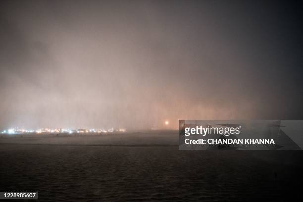 An oil and gas processing plant is seen as Hurricane Delta makes landfall in Lake Charles, Louisiana on October 9, 2020. - Hurricane Delta made...
