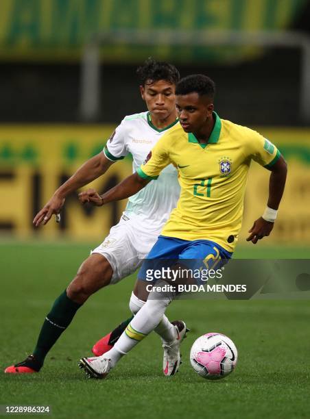 Brazil's Rodrygo and Bolivia's Jose Sagredo vie for the ball during their 2022 FIFA World Cup South American qualifier football match at the Neo...