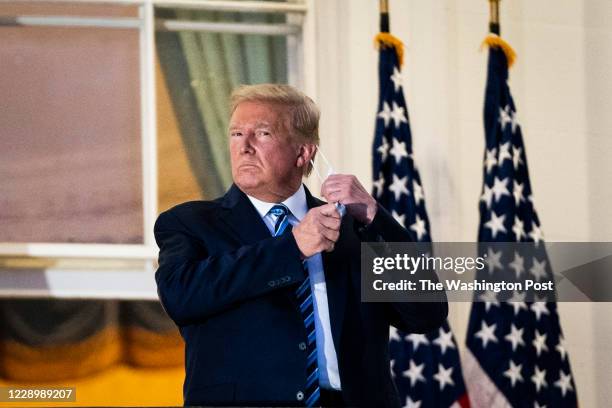 President Donald J. Trump watches Marine One from the Truman Balcony as he returns home after receiving treatments for the covid-19 coronavirus at...