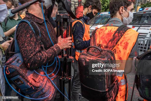 Journalists are seen covered with colors after protesters threw colored powder at police officers guarding the France railway station....