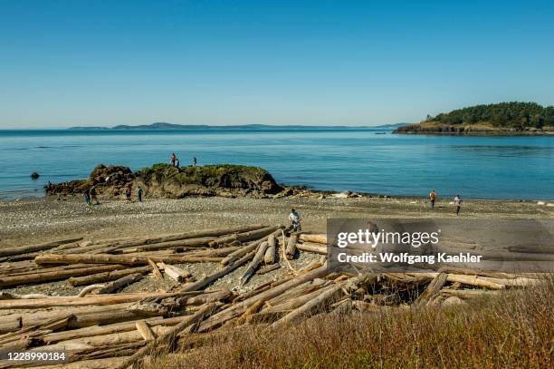 People on West Beach of Deception Pass State Park on Whidbey Island, Washington State, United States.