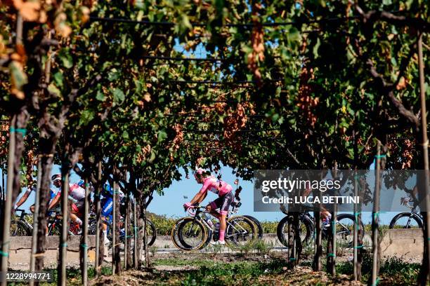 Team Deceuninck rider Portugal's Joao Almeida wearing the overall leader's pink jersey competes in the 8th stage of the Giro d'Italia 2020 cycling...