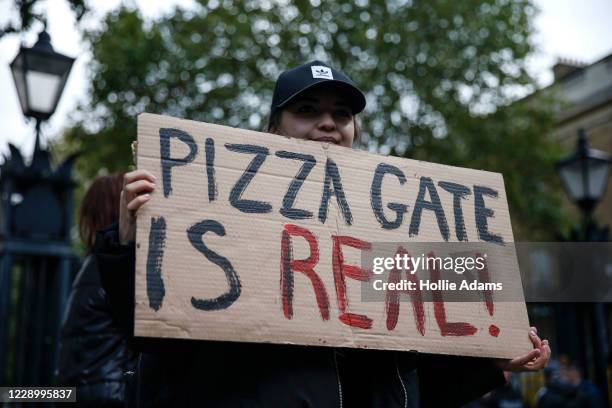 Protestor holds a sign during a "Save our Children" rally outside Downing Street on October 10, 2020 in London, England. During the demonstration,...