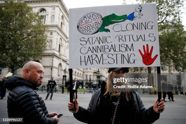Protestor holds a sign during a "Save our Children" rally outside Downing Street on October 10, 2020 in London, England. During the demonstration,...