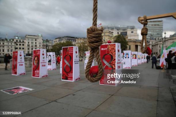 People visit an exhibition displaying prisoners who were put to death in Iran, to protest the death sentence during the World Day Against the Death...