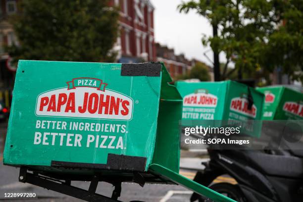 Papa John's pizza delivery bikes seen parked outside its branch in London.