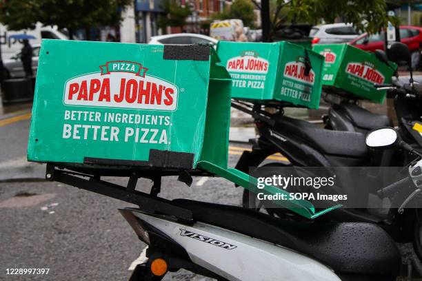 Papa John's pizza delivery bikes seen parked outside its branch in London.