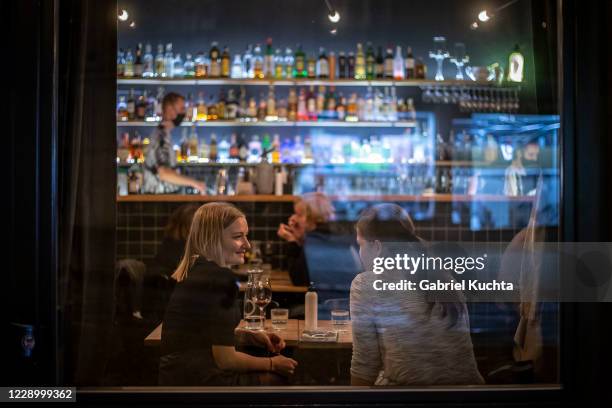 People drink in a bar shortly before closing time on October 10, 2020 in Prague, Czech Republic. After relaxing almost all restrictive measures in...