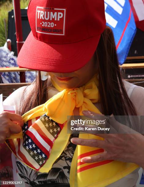 Holly Tran, who was born in Vietnam but now lives in Everett, Washington afixes her scarf bearing the flag colors from the United States and Vietnam...