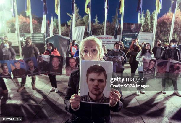 Protester holding a placard with an image during the demonstration. Ukrainian prisoners of war and civilians held a protest in the territories...