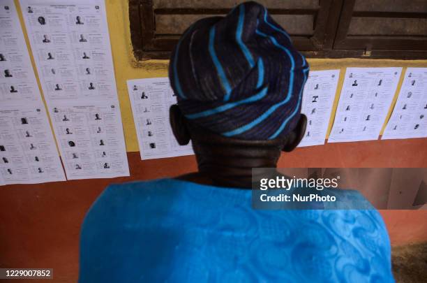 Man checks on INEC list before voting at scared heart primary in schoolGbogi/Isikan, in Akure South Ondo State, during the Ondo governorship election...