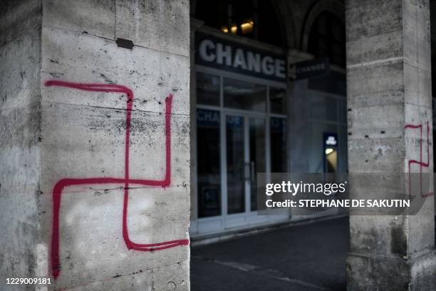 Picture shows swastikas spray painted on columns of the Rivoli street in central Paris on October 11, 2020.