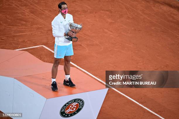 Spain's Rafael Nadal celebrates with the Mousquetaires Cup during the podium ceremony after winning the men's singles final tennis match against...