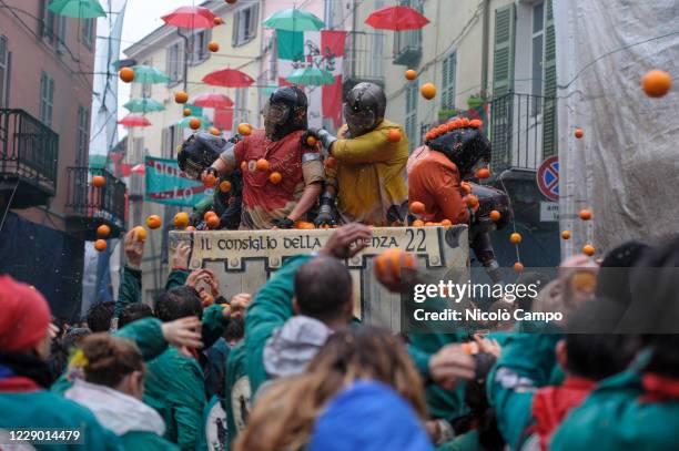 The pedestrian team of orange throwers "Tuchini del Borghetto" fight against a cart during the Battle of the Oranges that takes place every year...