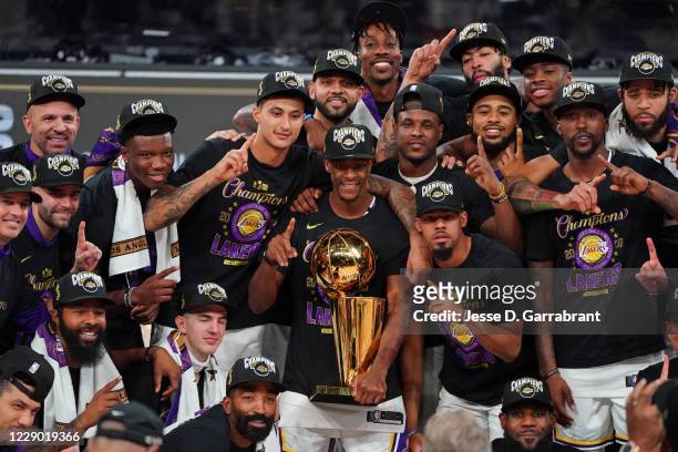 The Los Angeles Lakers celebrate with the Larry O'Brien Trophy on court after winning Game Six of the NBA Finals against the Miami Heat on October...