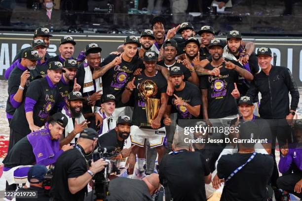 The Los Angeles Lakers celebrate with the Larry O'Brien Trophy on court after winning Game Six of the NBA Finals against the Miami Heat on October...