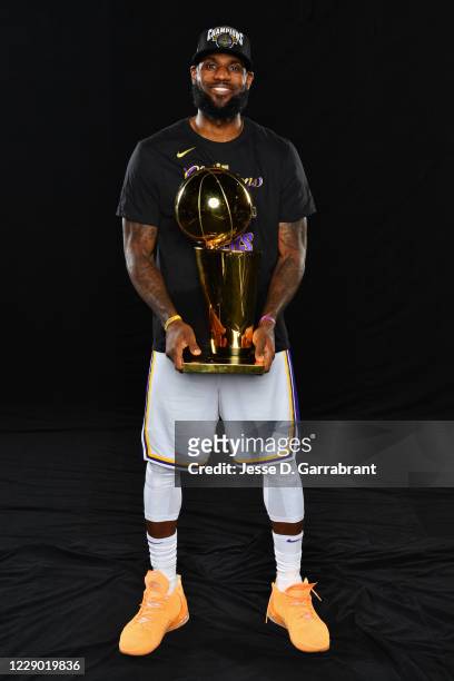 LeBron James of the Los Angeles Lakers poses for a photo with the Larry O'Brien Trophy after winning Game Six of the NBA Finals against the Miami...