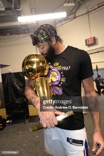 Anthony Davis of the Los Angeles Lakers kisses the Larry O'Brien Championship Trophy after winning Game Six of the NBA Finals on October 11, 2020 at...