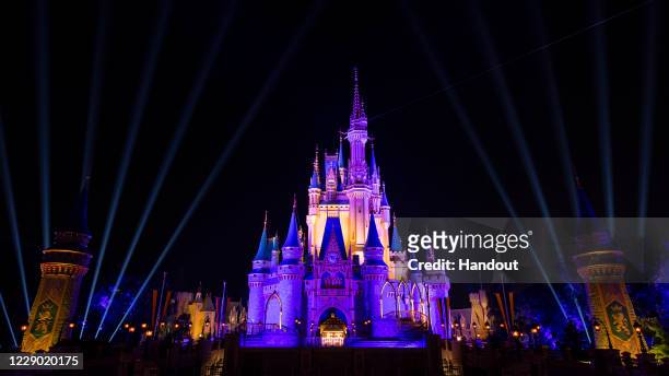 Cinderella Castle inside the Magic Kingdom Park is lit purple and gold in honor of the Los Angeles Lakers winning the 2020 NBA Final on October 11,...